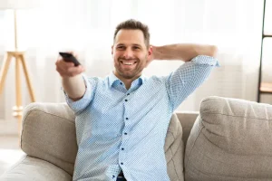 happy-guy-watching-tv-home-holding-remote-control-relax-concept-smiling-calm-man-shirt-watching-tv-couch-home-187244998