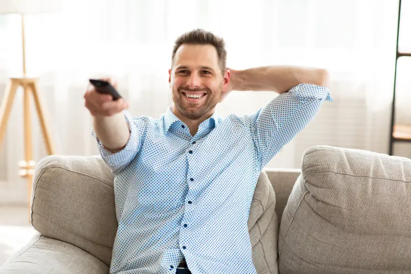 happy-guy-watching-tv-home-holding-remote-control-relax-concept-smiling-calm-man-shirt-watching-tv-couch-home-187244998